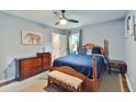 Cozy bedroom featuring a wooden bed frame, soft blue bedding, and matching side tables at 1626 Oak Knoll Se Cir, Atlanta, GA 30315