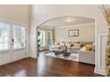 Inviting living room with hardwood floors, large sectional sofa, and plenty of natural light from large windows at 305 Spooner Dr, Mcdonough, GA 30252