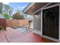 Welcoming front entrance with a patio area, adorned with a decorative wreath and outdoor furniture at 4941 Meadow Lane, Marietta, GA 30068