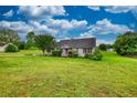 A well-kept ranch home, set back on a sprawling green lawn with mature trees and charming curb appeal at 2068 Hampton Locust Grove Rd, Locust Grove, GA 30248