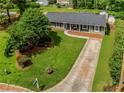 Aerial view of a landscaped front yard with mature trees and a long driveway at 620 Clearbrook Ct, Marietta, GA 30068