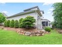 Spacious backyard featuring mature trees, lush lawn, and a charming stone retaining wall at 2578 Middle Coray Cir, Marietta, GA 30066