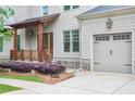 Home featuring a covered porch, a two-car garage, and manicured landscaping at 2578 Middle Coray Cir, Marietta, GA 30066