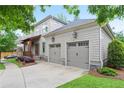 A two-car garage with carriage doors complements the home's shingle siding and well-maintained front yard at 2578 Middle Coray Cir, Marietta, GA 30066
