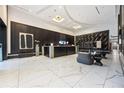 Elegant lobby with modern lighting, white marble floors, dark wood paneling, and comfortable seating area at 400 W Peachtree Nw St # 3614, Atlanta, GA 30308