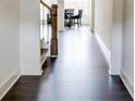 Hallway featuring dark hardwood floors and white trim throughout the living space at 7621 Avalon Blvd, Fairburn, GA 30213