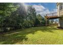 Spacious backyard with lush green lawn and mature trees, perfect for outdoor activities at 981 Charles Hall Dr, Dacula, GA 30019