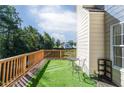 Outdoor deck with artificial grass, a small table, and seating, perfect for relaxing at 981 Charles Hall Dr, Dacula, GA 30019