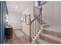 Spacious foyer showcasing the staircase, wood floors, and stylish decor upon entering this home at 290 Abbotts Crossing Cir, Conyers, GA 30094