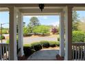 Inviting front porch with classic columns and well-maintained landscaping creates an excellent first impression at 5029 Preservation Pointe, Kennesaw, GA 30152