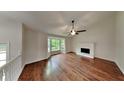Spacious living room featuring hardwood floors, a fireplace, and bay windows at 64 Little John Way, Douglasville, GA 30134