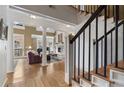 Elegant living room with a fireplace, beautiful hardwood floors, and grand design at 77 Peachtree Ne Pl # 608, Atlanta, GA 30309