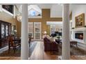 Elegant living room featuring a fireplace, soaring ceilings, and beautiful hardwood floors at 77 Peachtree Ne Pl # 608, Atlanta, GA 30309