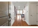 Hallway view showcasing the hardwood floors and the open floor plan, leading to the kitchen and living areas at 1261 Caroline Street Ne # 206, Atlanta, GA 30307