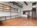 Open concept living area featuring wood floors, shelving, and stairs to upper level at 1261 Caroline Street Ne # 206, Atlanta, GA 30307