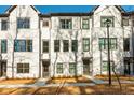 Beautiful new construction townhome with painted brick, dark trim and a sidewalk leading to the front door at 1371 Walking Way, Atlanta, GA 30316
