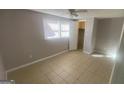 Bright bedroom with ceiling fan, closet, and tile floors at 2391 Randall Ave, Lithonia, GA 30058