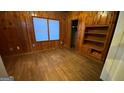 Bedroom with wood paneled walls and built-in shelving at 2391 Randall Ave, Lithonia, GA 30058