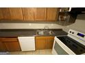 This kitchen features a range, a double sink, and a dishwasher, offering practicality at 2391 Randall Ave, Lithonia, GA 30058