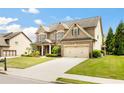 Beautiful two-story home featuring a lush lawn, two-car garage, and a welcoming facade at 4779 Moon Hollow Ct, Buford, GA 30519
