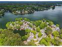 Stunning aerial view of a lakeside community featuring lush greenery and waterfront properties with private docks and boats at 6330 Spinnaker Ln, Alpharetta, GA 30005
