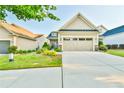 Attractive home with a two-car garage and well-maintained landscaping at 5641 Tisbury Ct, Hoschton, GA 30548