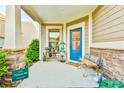 Cozy covered front porch with seating and charming decor at 5641 Tisbury Ct, Hoschton, GA 30548