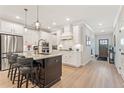 Modern kitchen featuring a large island with seating, stainless steel appliances, and ample cabinet space at 3672 Silvery Way, Powder Springs, GA 30127