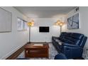 Comfortable living room featuring contemporary decor, hardwood floors, a sleek TV, and a comfortable blue leather couch at 381 Ralph Mcgill Ne Blvd # K, Atlanta, GA 30312