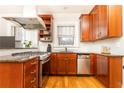Kitchen showcasing stainless steel oven, dishwasher, granite countertops, and light wood cabinetry at 1125 Briarcliff Ne Pl # 14, Atlanta, GA 30306