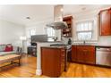 Well-appointed kitchen featuring wood cabinets, granite countertops, stainless steel appliances, and an island with a gas cooktop at 1125 Briarcliff Ne Pl # 14, Atlanta, GA 30306