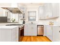 Bright kitchen featuring white cabinetry, stainless steel appliances, and hardwood flooring for a clean, modern aesthetic at 1125 Briarcliff Ne Pl # 14, Atlanta, GA 30306
