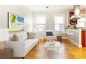 Inviting living room features modern furnishings, bright windows, and gleaming hardwood floors, creating a cozy and stylish space at 1125 Briarcliff Ne Pl # 14, Atlanta, GA 30306
