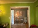 Bright entryway with views to the hall, featuring hardwood floors, decorative artwork, and neutral colors at 1935 Flat Shoals Se Rd, Conyers, GA 30013