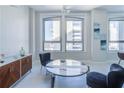 Bright sitting area features a sleek marble table set and art at 20 Marietta Nw St # 15D, Atlanta, GA 30303