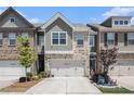 Charming townhome featuring a two-car garage and a beautifully landscaped front yard at 2404 Fitts Dr, Conyers, GA 30094