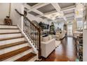 Bright living room with hardwood floors, coffered ceilings and elegant staircase at 2404 Fitts Dr, Conyers, GA 30094