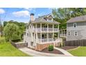 Side view of a two-story house with a double porch, showcasing its well-maintained lawn at 925 Hill Se St, Atlanta, GA 30315