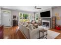 Open-concept living room with fireplace, large windows, and hardwood floors at 925 Hill Se St, Atlanta, GA 30315
