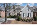Inviting two-story home features a combination of stone and siding, creating a classic and elegant facade at 185 Windsor Cv, Sandy Springs, GA 30328