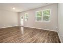 Spacious living room with hardwood floors, natural light, and access to the backyard at 1881 Millstream Holw, Conyers, GA 30012
