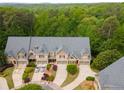 Aerial view of luxury townhomes surrounded by lush green trees and manicured lawns at 320 Wisteria Cir, Roswell, GA 30076