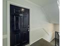 Black door leading to apartment features a sleek design and staircase at 3301 Henderson Mill Rd # D3, Atlanta, GA 30341