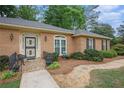 Inviting front entrance with a decorative door, well-maintained landscaping, and stone walkway at 4066 Brymond Ct, Tucker, GA 30084