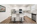 Modern kitchen with stainless steel appliances, granite countertops, and a stylish island with bar stool seating at 108 Berwick Crossing, Dallas, GA 30157
