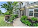 Close up view of the welcoming front porch and door of this charming two-story home at 3399 In Bloom Way, Auburn, GA 30011