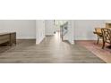 Bright hallway with sleek flooring, detailed trim work, leading to the dining area and staircase at 1606 Chancery Ln, Lithia Springs, GA 30122