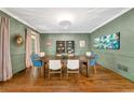 Stylish dining room featuring elegant wall decor, a modern chandelier, and hardwood floors at 3925 Sheldon Ne Dr, Atlanta, GA 30342