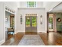 Inviting foyer with hardwood floors, high ceilings, and decorative mirrors offering a view to the outdoors at 3925 Sheldon Ne Dr, Atlanta, GA 30342