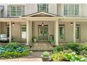 Elegant front porch with stone steps, columns, and tasteful landscaping, creating a welcoming entrance at 3925 Sheldon Ne Dr, Atlanta, GA 30342